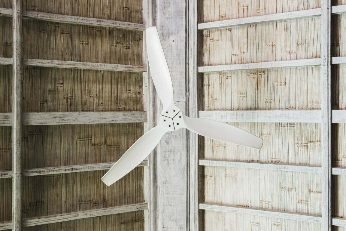 White ceiling fan under wooden roof, tropical house interior